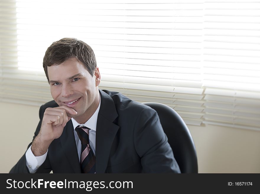 Smiling businessman in his Office