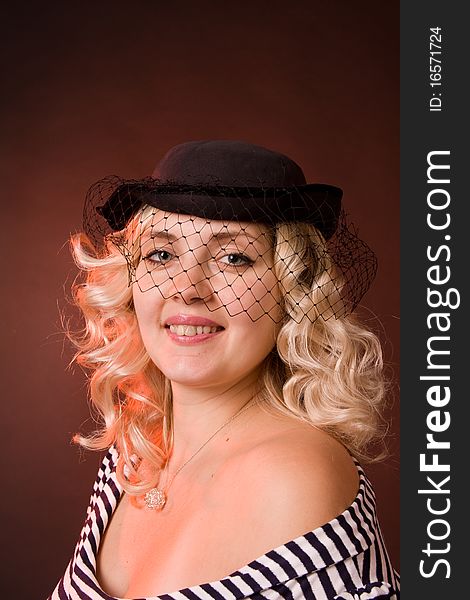 Beautiful young woman in a hat with a veil