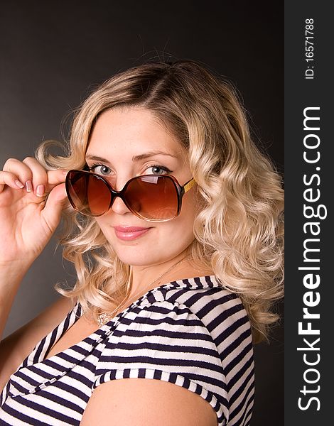 Photo of beautiful young woman of blonde is in sunglasses