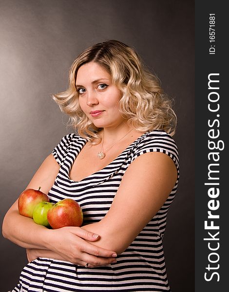 Photo of beautiful young pregnant woman of blonde with apples.