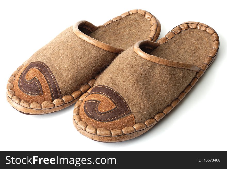 Slippers made of felt and leather on white background
