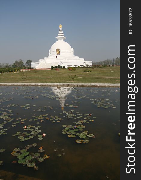 A buddhist temple in Nepal with reflection and blue sky