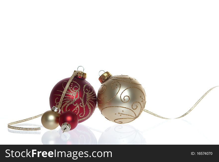 Red and Gold Baubles with reflection isolated on white