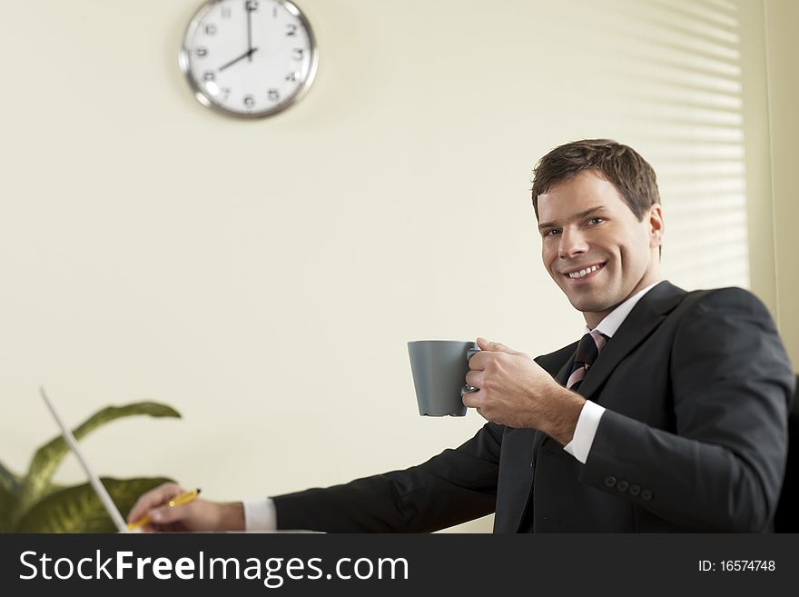Businessman working on laptop with a coffee