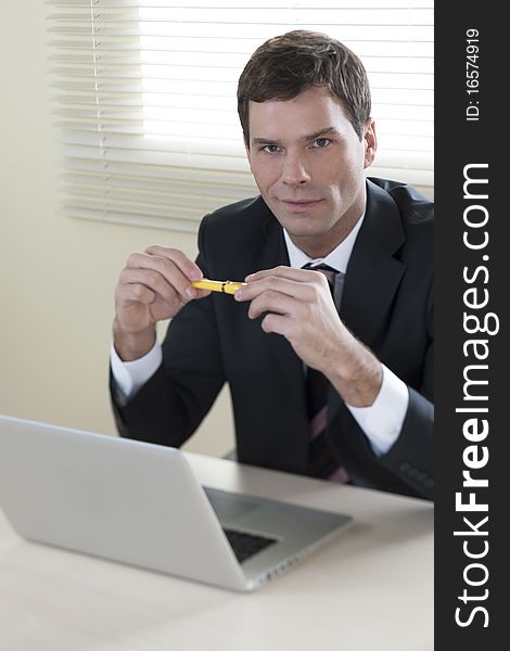 Businessman working on laptop in his office
