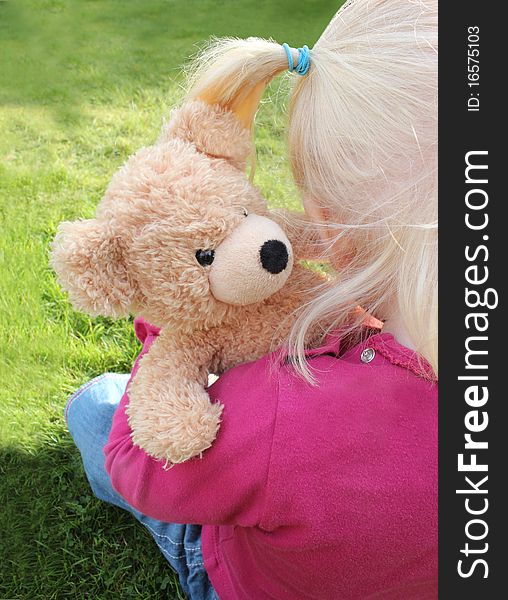 Child Cuddling Teddy Bear