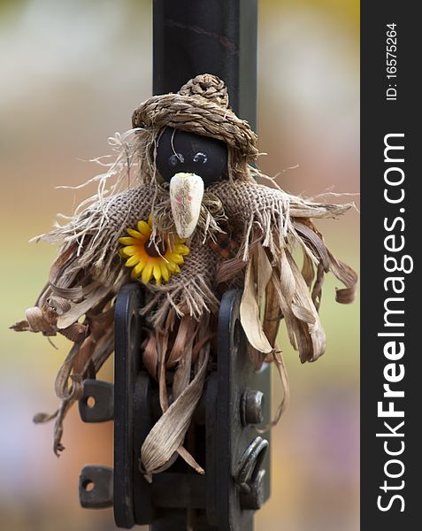 A miniature scarecrow hung up for Halloween. A miniature scarecrow hung up for Halloween