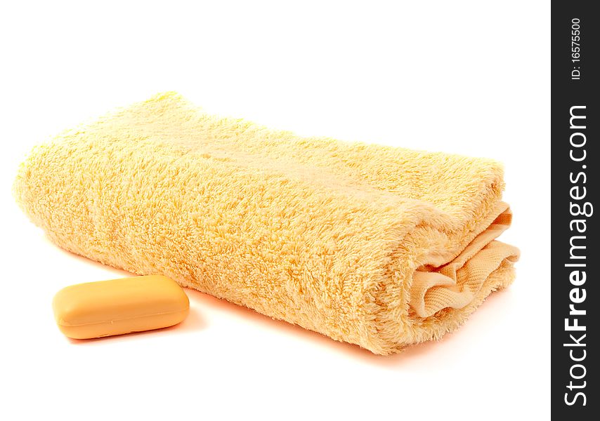 Yellow towel and soap on a white background