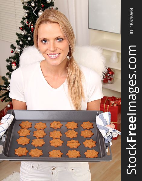 Beautiful blond angel with some fresh christmas cookies. Beautiful blond angel with some fresh christmas cookies