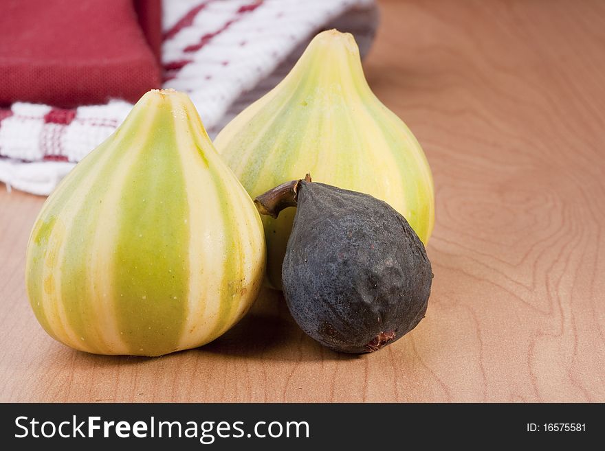 Ripe fruits of a fig on a wooden table.