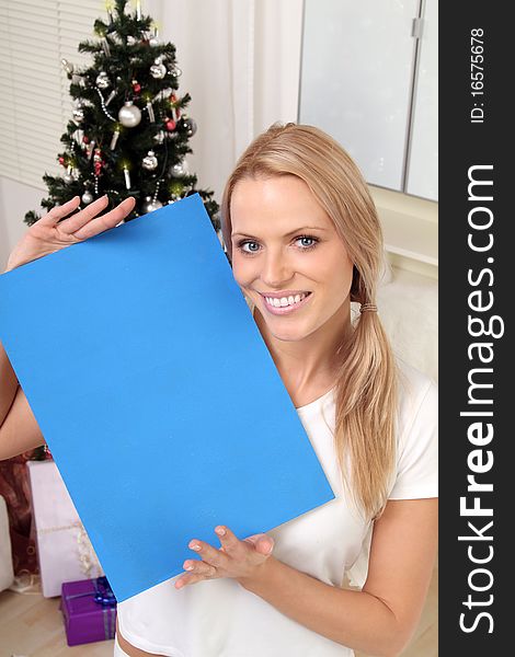 Beautiful blond christmas-angel holding a sign. Beautiful blond christmas-angel holding a sign
