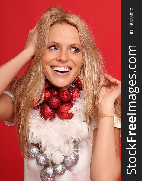 Beautiful young woman with some christmas balls around the neck. Beautiful young woman with some christmas balls around the neck