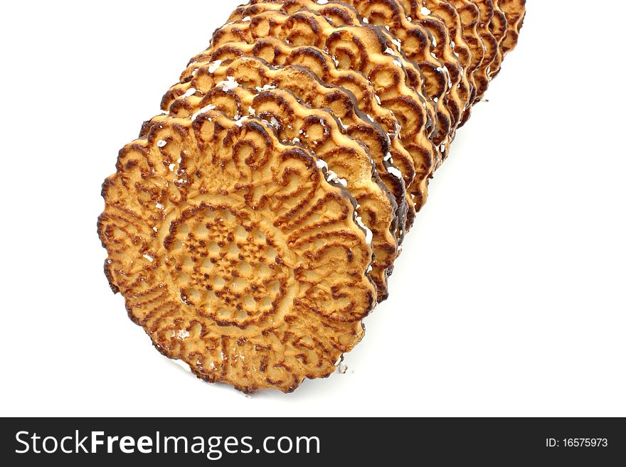 Chocolate round cookies with a coconut shaving lie on a white background. Chocolate round cookies with a coconut shaving lie on a white background