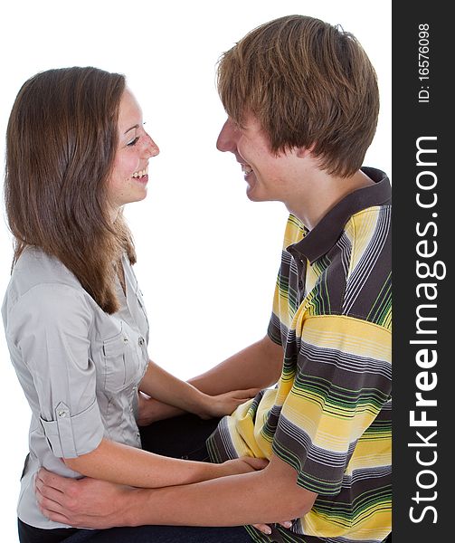 Two teenagers in love. Studio portrait isolated over white background.