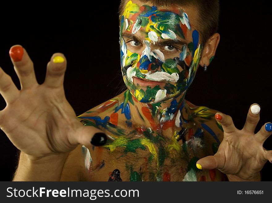 Young guy face, body and hands painted with colored ink. Young guy face, body and hands painted with colored ink