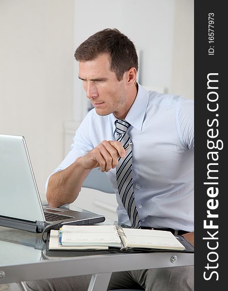 Man working in the office with laptop computer. Man working in the office with laptop computer