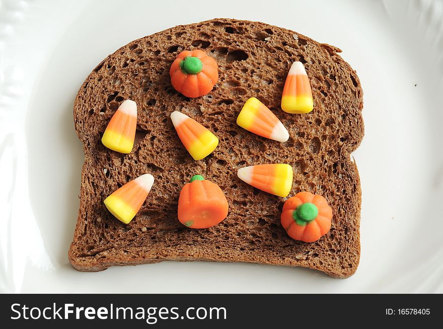 An unhealthy halloween snack. A candycorn and bread sandwich!