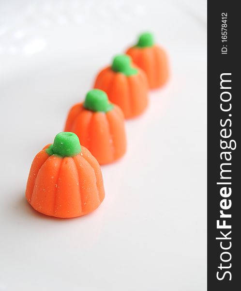 Row of sweet halloween candy pumpkins on white background. Row of sweet halloween candy pumpkins on white background