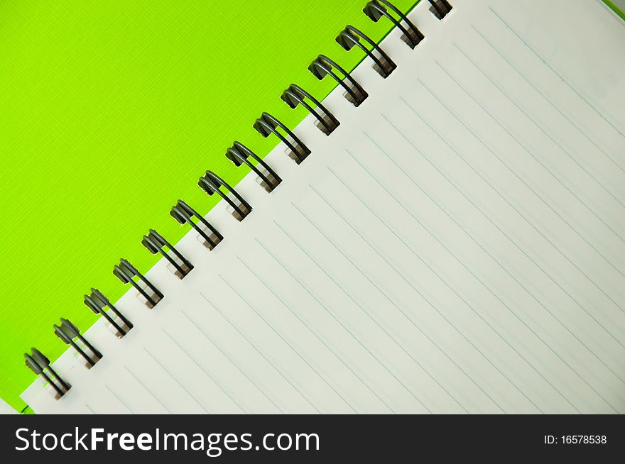 Isolated green notebook on white.