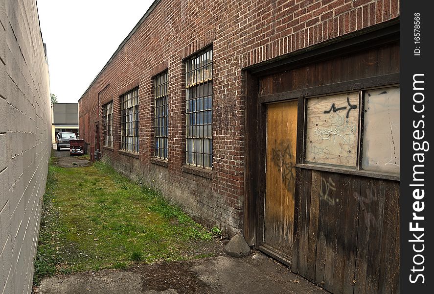 An old worn out alley way with a brick building