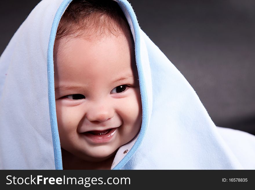 Baby Smiling with blanket on his head