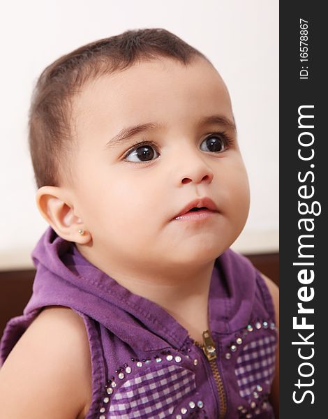 Serious baby looking up over white background