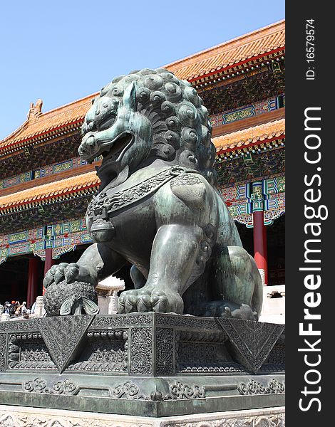 Lion Statue standing to protect the gates of the Forbidden City in Beijing, China.