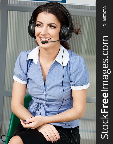 Girl commentator with headset on the tribune