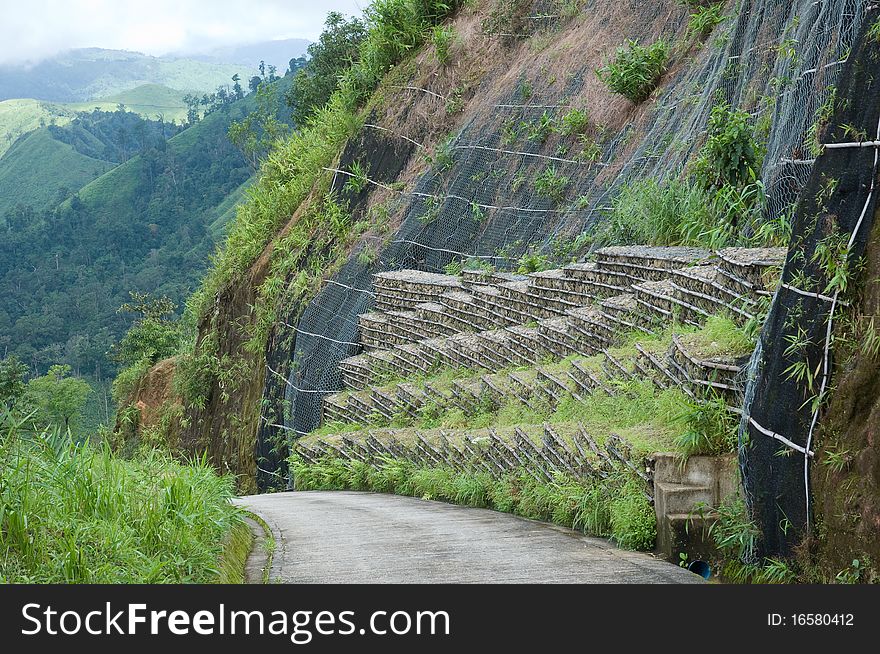 Protective wall rock save the rock fall on the road between mountain