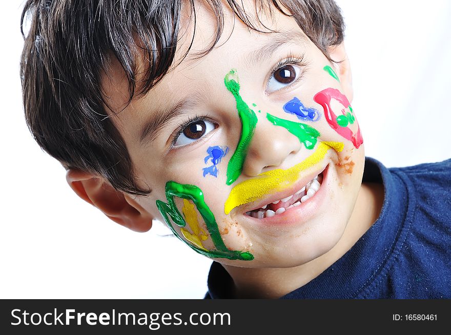 Messy cute kid with colors on his face, funny scene