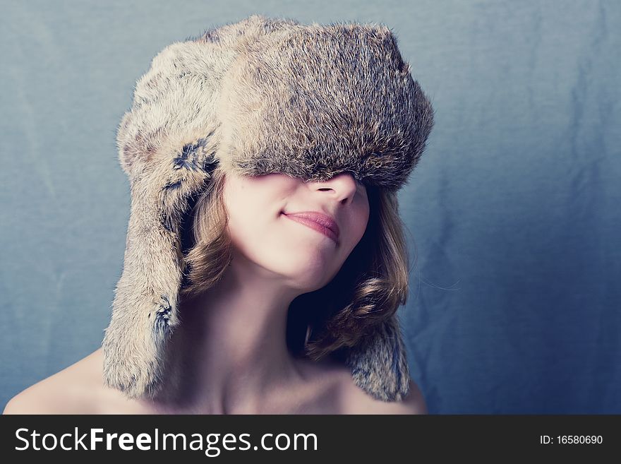 Fine art portrait of a woman in a fur winter cap. Fine art portrait of a woman in a fur winter cap