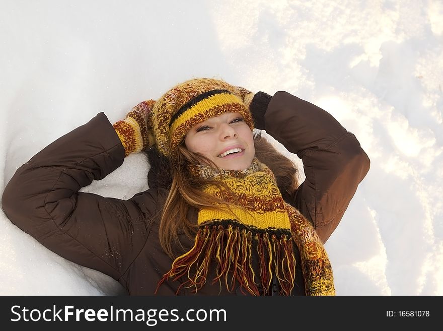 Cheerful girl in winter hat and mittens