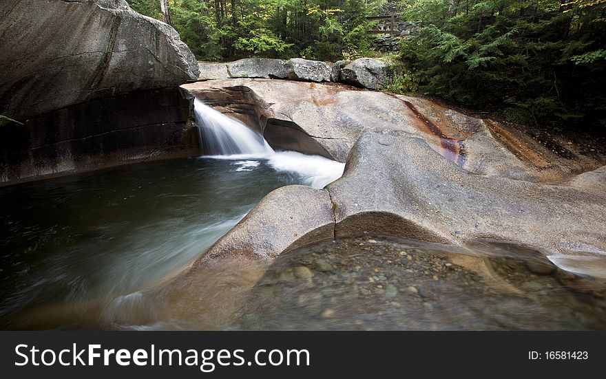 Waterfall at the basin in New Hampshire in early autumn