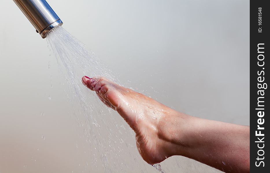 Detail of a girl's foot and water jet