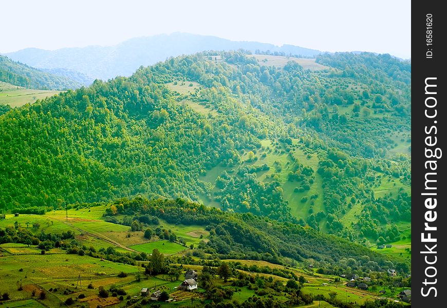 Ukrainian tranquil landscape with green meadow and blue mountains. Ukrainian tranquil landscape with green meadow and blue mountains.