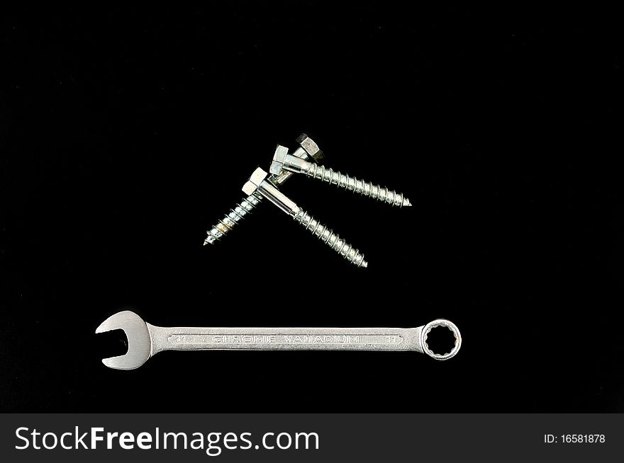 Ringpanner and screw on a black background. Ringpanner and screw on a black background