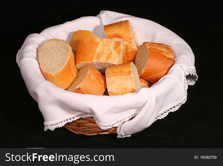 Picture of basket with bread pieces over a black background. Picture of basket with bread pieces over a black background