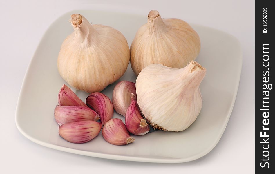 White dish with several garlics. White dish with several garlics