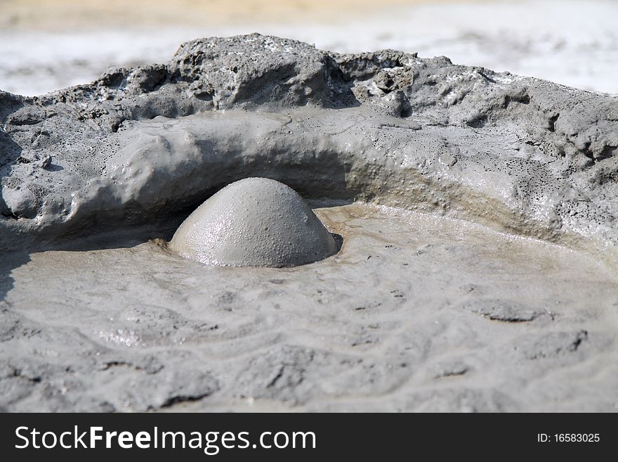 Mud Volcano in Buzau, Romania. The small volcano-shaped structures are caused by the eruption of mud and volcanic gases. Mud Volcano in Buzau, Romania. The small volcano-shaped structures are caused by the eruption of mud and volcanic gases.