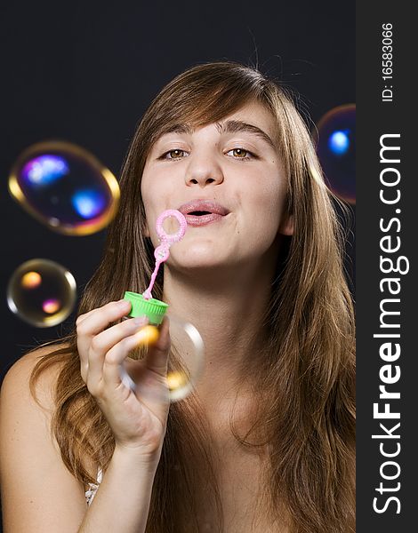 Young woman playing with bubbles. Young woman playing with bubbles