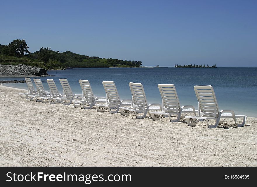 Row of chairs standing at the beach. Row of chairs standing at the beach