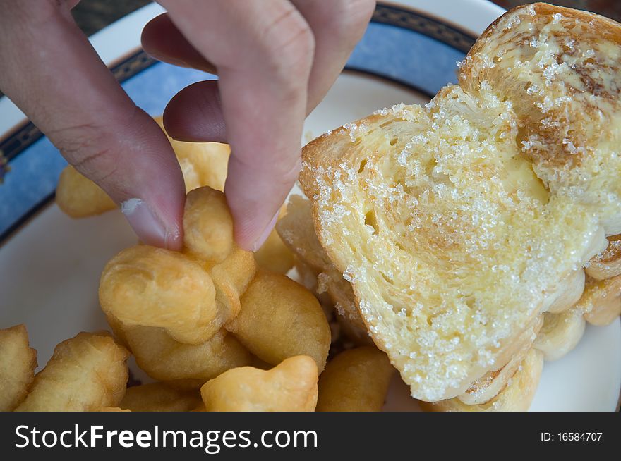 Deep-fried dough stick and toast with sugar and condensed milk. Deep-fried dough stick and toast with sugar and condensed milk