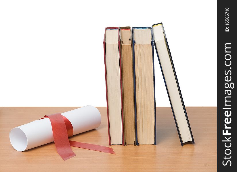 Scroll with red ribbon and books