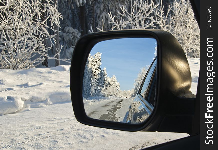 Passing winter pass in side-view mirror. Passing winter pass in side-view mirror