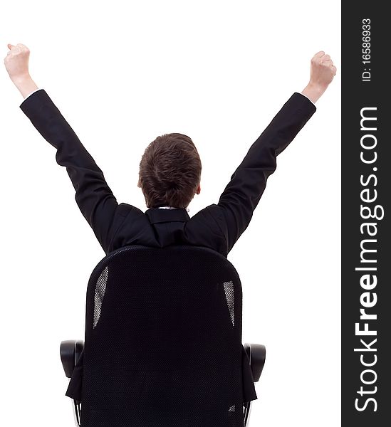 Bac picture of a business woman sitting in a chair and with her hands in the air celebrating success