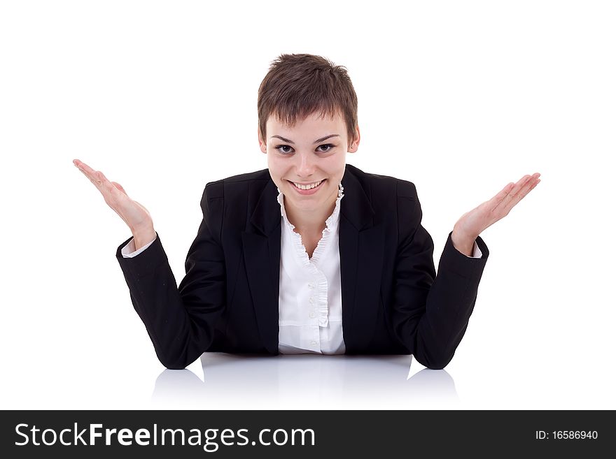 Young beautiful business woman behind the desk with open arms, isolated