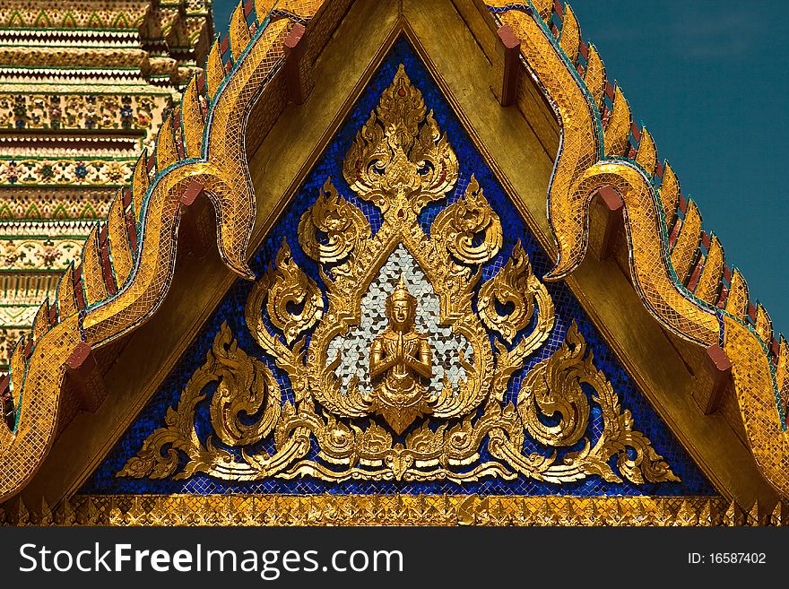 Buddhist angel at the triangular end of the temple roof. Buddhist angel at the triangular end of the temple roof