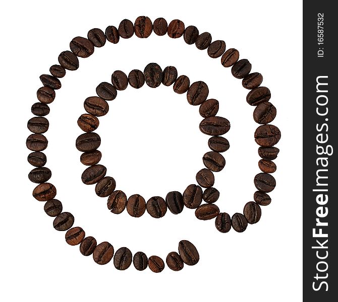 Coffee beans lying in the shape of at sign. Coffee beans lying in the shape of at sign