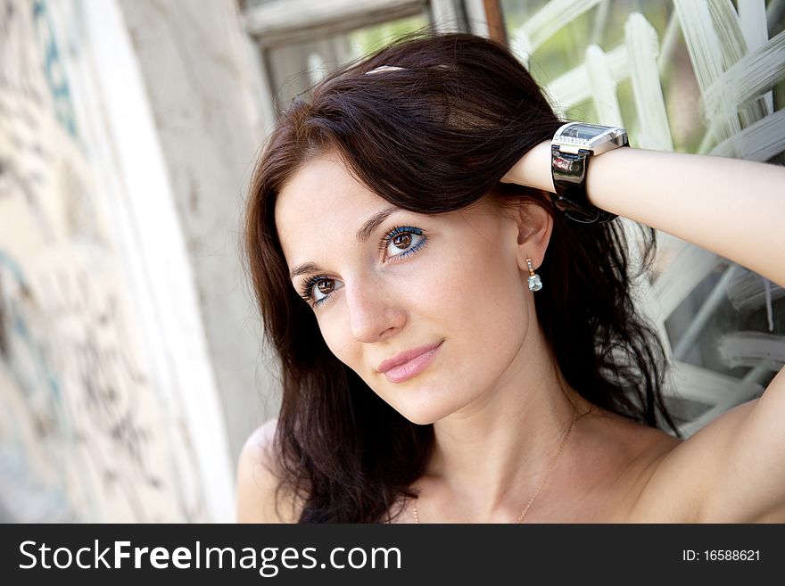 Young attractive woman near the wall with graffiti