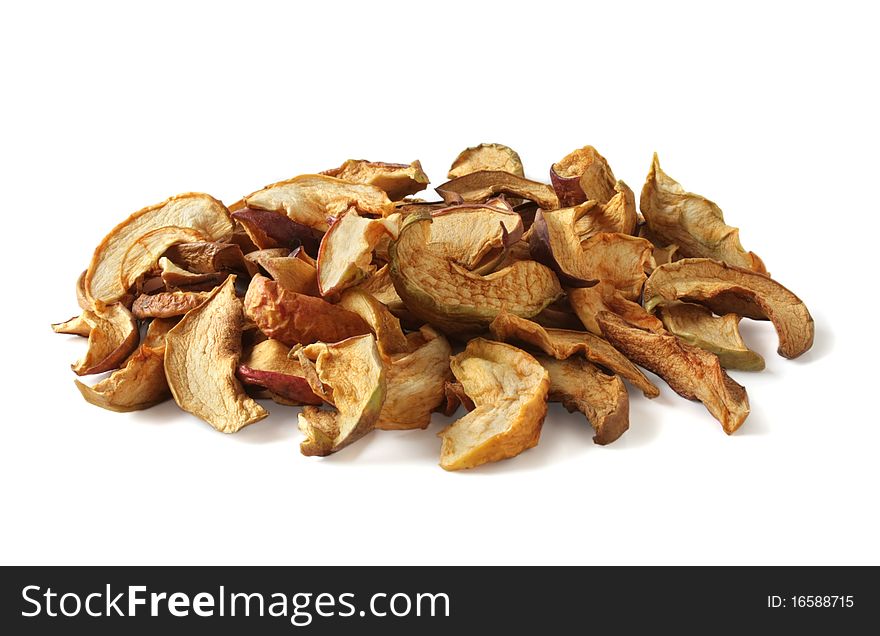 Dried apples are heaped on a white background. Dried apples are heaped on a white background